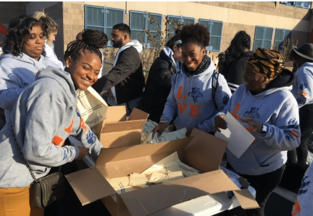 This image captures a group of women participating in the Chopra & Nocerino turkey giveaway in Brooklyn.