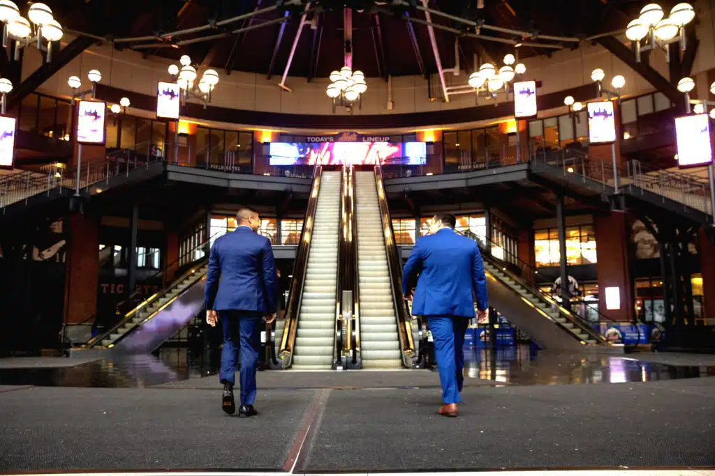 Injury attorneys, Sameer Chopra and Alex Nocerino walking towards steps at the Mets stadium
