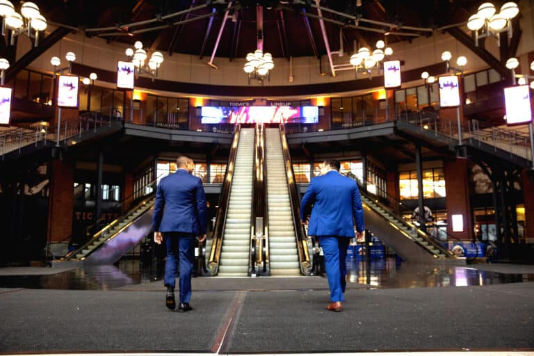 Injury attorneys, Sameer Chopra and Alex Nocerino walking towards steps at the Mets stadium