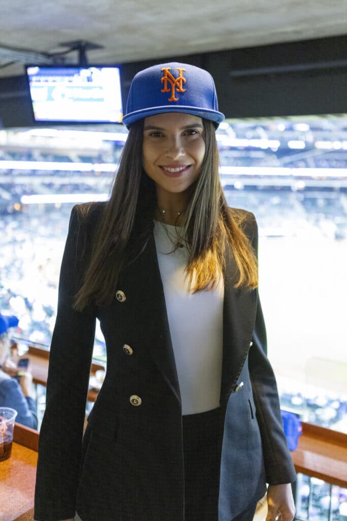 Member of the Chopra & Nocerino team with New York Mets baseball hat on at game