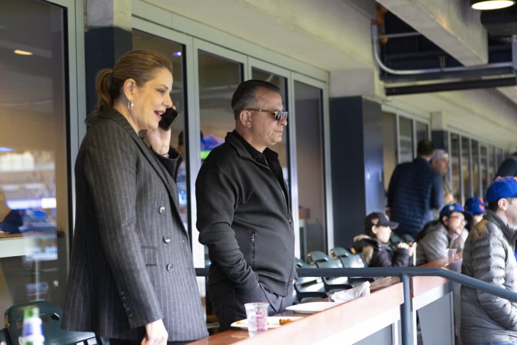 Two people in stands watching New York Mets Game