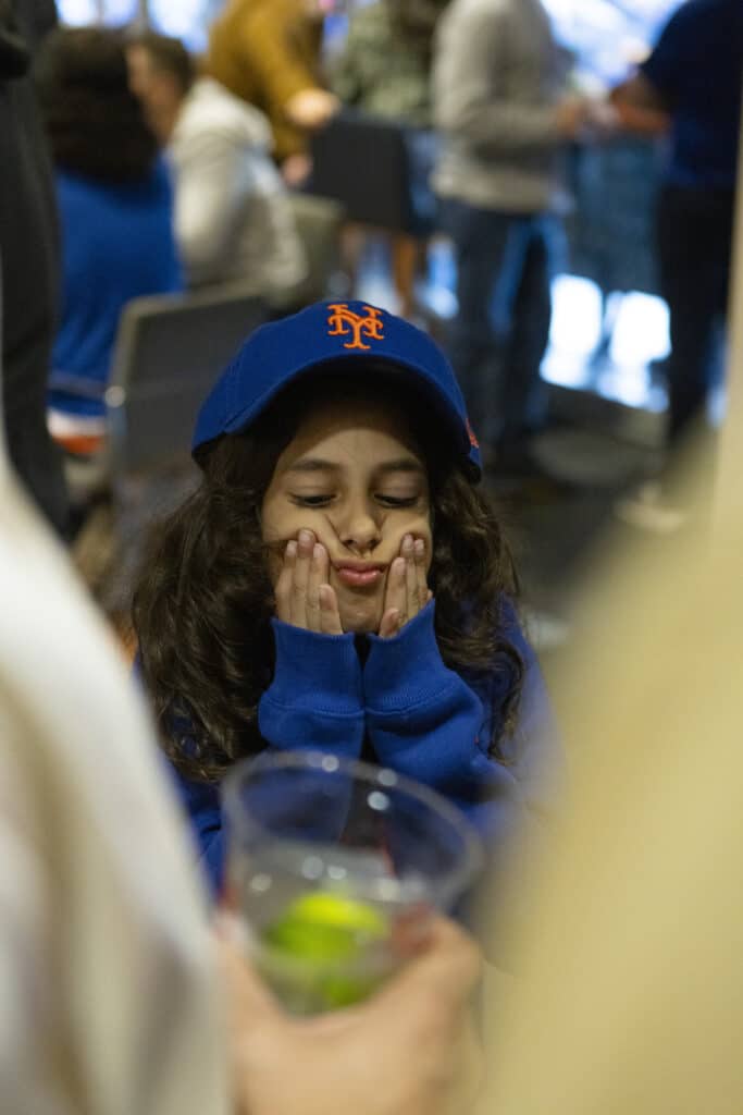 Sameer Chopra daughter in New York Mets hoodie and baseball cap