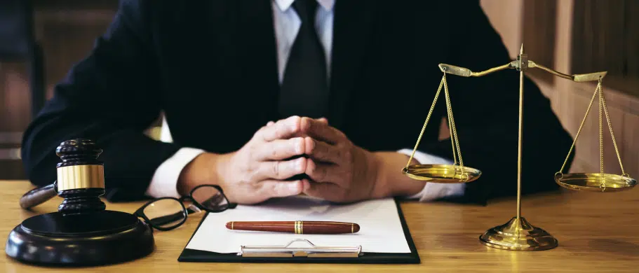 car accident lawyer sitting at a desk with a pen and paper in front of them