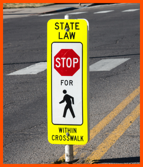 The image depicts a traffic sign with the words "STOP FOR PEDESTRIANS" in bold, typically yellow letters on a red background.