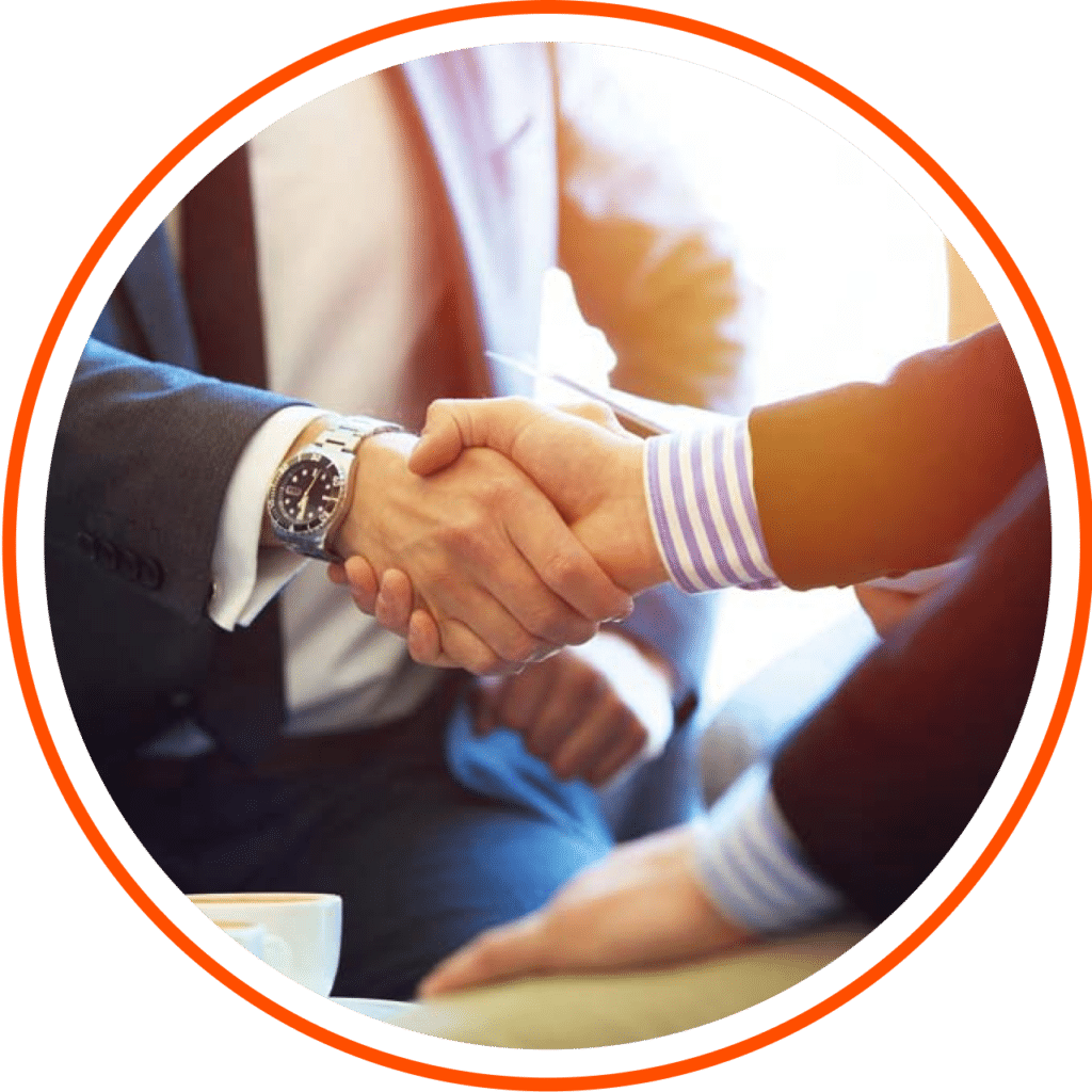 The image focuses solely on a handshake between two individuals. Both hands are dressed in suit sleeves, indicating a formal or professional interaction.
