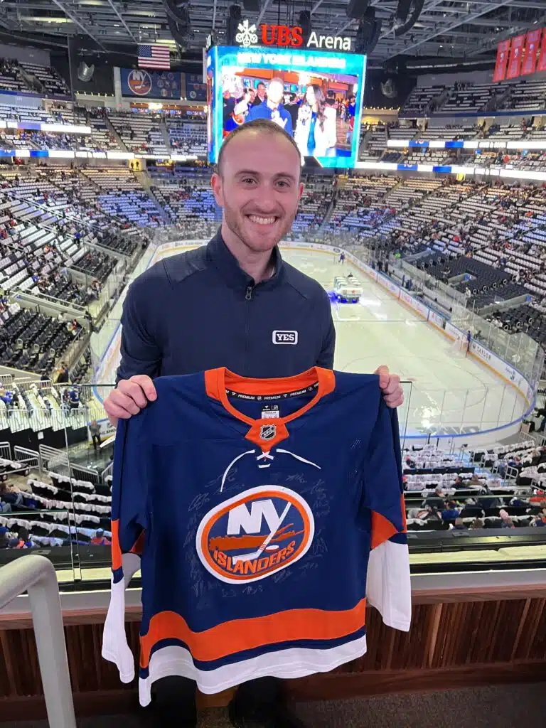 Ben holding one of the signed jerseys