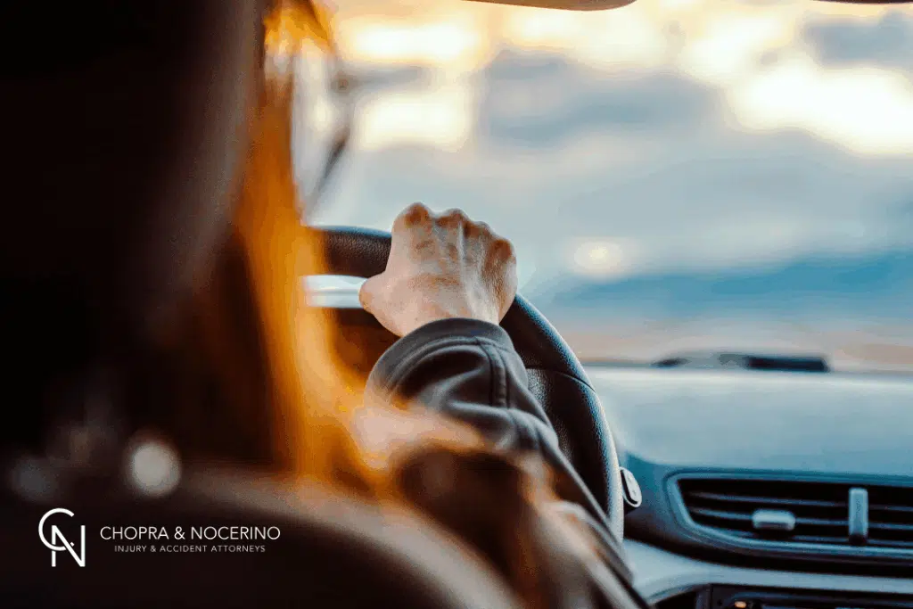 back of a female's head that is driving a rental car
