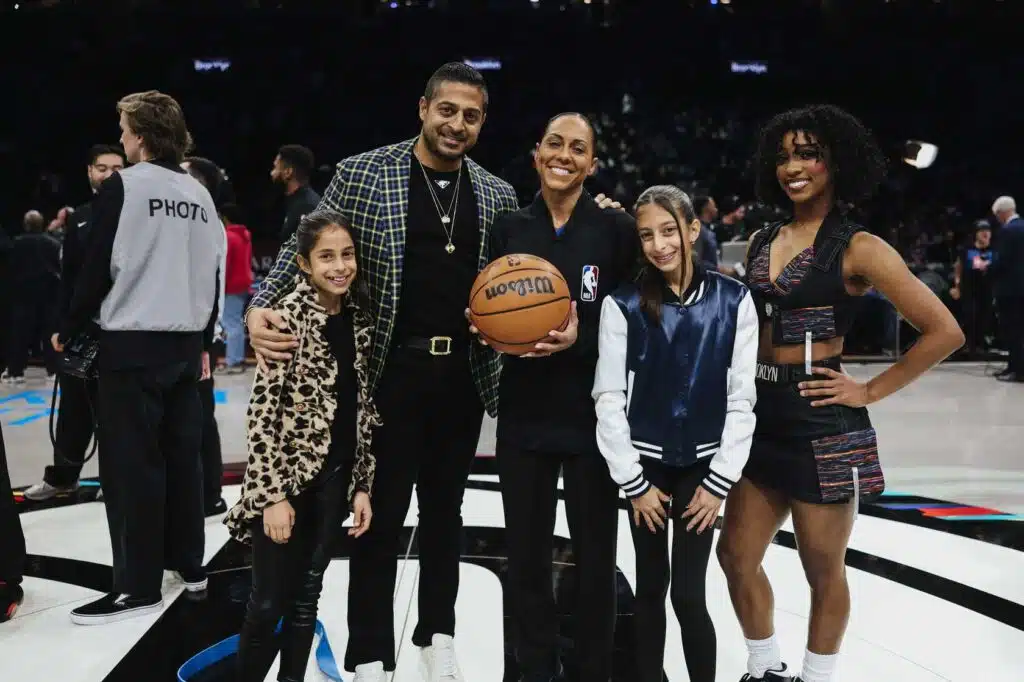 Sameer Chopra with his two daughters and two members of the team staff