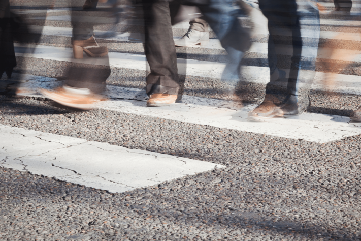 Blurry pedestrians crossing street in Brooklyn, NY