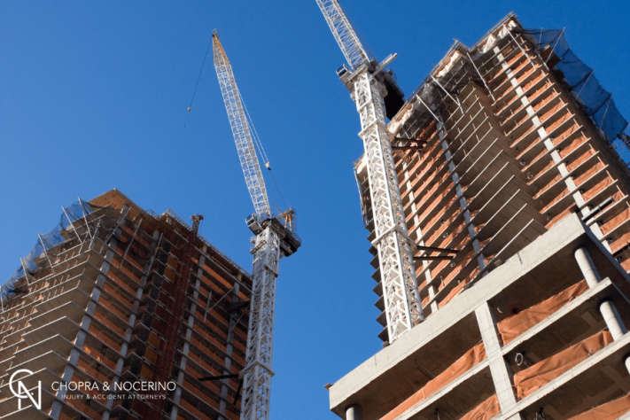 New York City, Manhattan construction site with cranes moving materials