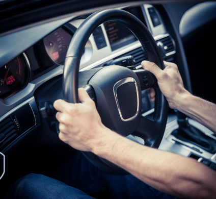 hands gripped on a steering wheel