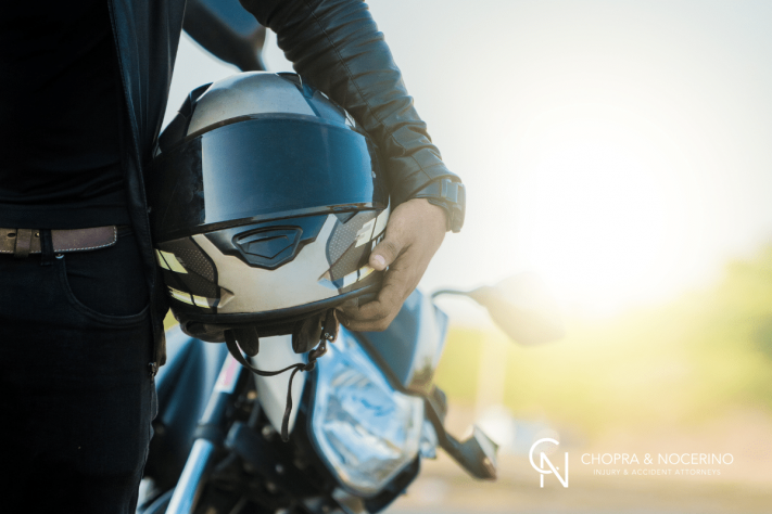 man holding a motorcycle helment on his side